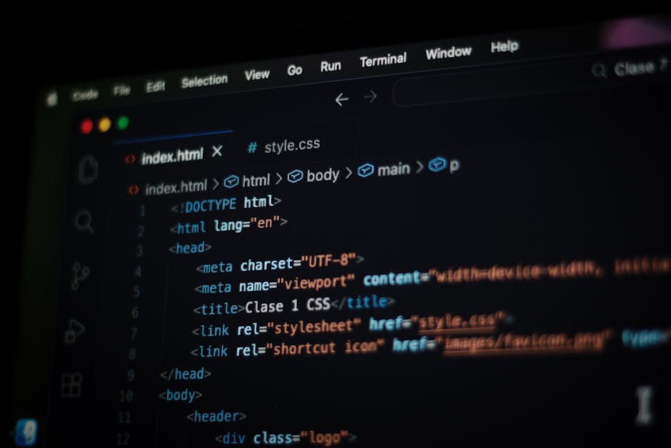 A close-up photograph of a computer screen displaying lines of HTML and CSS code, with visible elements such as meta tags, title, links to stylesheet and favicon. The code is highlighted with differen